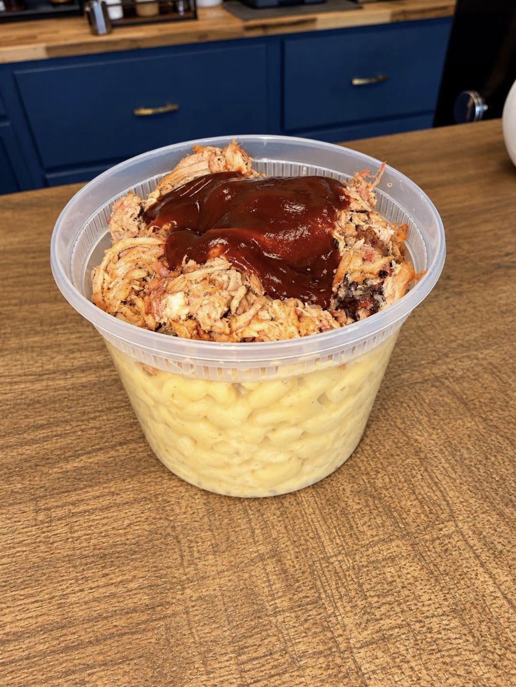 Pulled pork with barbecue sauce over mac and cheese